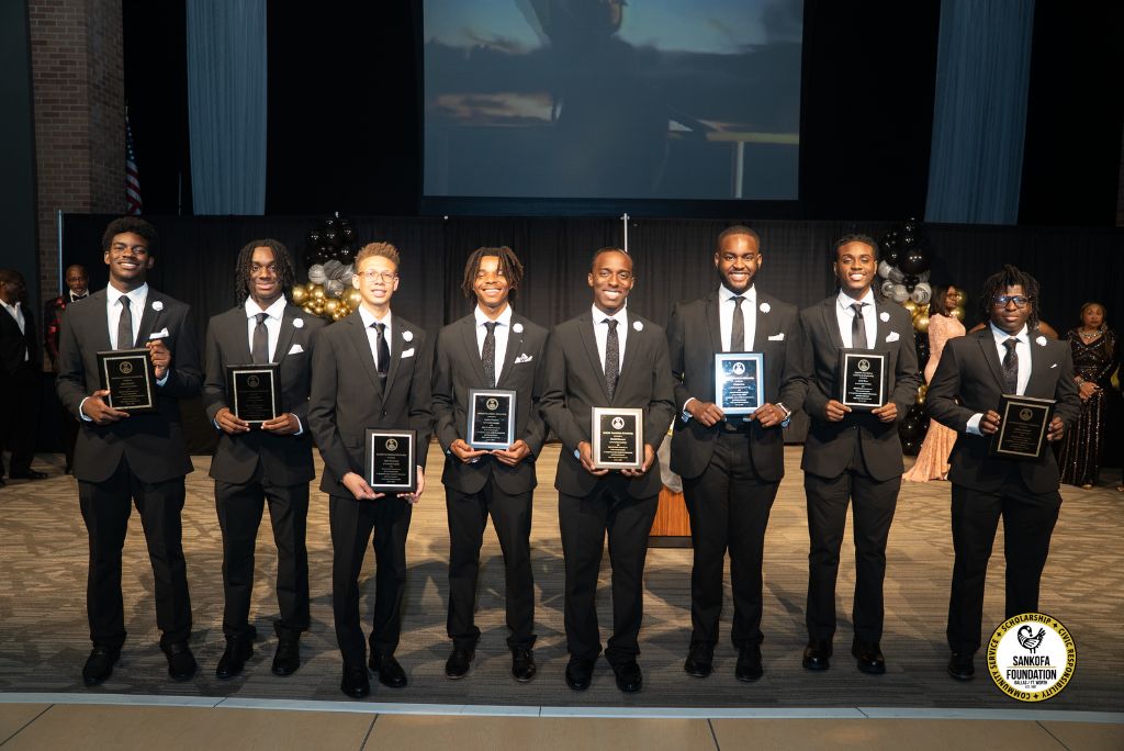 Sankofa Foundation scholarship recipients holding award plaques at the Alpha Legacy Scholarship Gala
